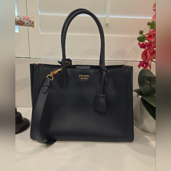 Prada Handbags - Prada city calf leather bag in navy blue.